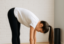 Pre-SAT Stretching & Breathing Exercises for Teen Focus Teen girl doing a forward fold stretch on a yoga mat before the SAT exam